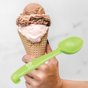 Branded plastic ice cream scoop shown with waffle cone and scoops of ice cream, used for serving frozen treats